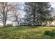 White farmhouse with a large backyard at 6720 Mebane Oaks Rd, Mebane, NC 27302