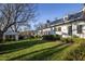 White two-story home with a metal roof and landscaping at 6720 Mebane Oaks Rd, Mebane, NC 27302