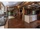 Spacious kitchen with an island, exposed beams, and brick flooring at 6720 Mebane Oaks Rd, Mebane, NC 27302