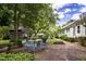Brick patio with metal table and chairs, nestled beside a charming historic home at 6720 Mebane Oaks Rd, Mebane, NC 27302