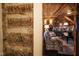 View of a rustic living room with exposed log walls and comfortable seating at 6720 Mebane Oaks Rd, Mebane, NC 27302