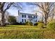 White farmhouse nestled on a spacious lawn at 6720 Mebane Oaks Rd, Mebane, NC 27302