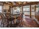 Open kitchen with large island, exposed beams, and brick floor at 6720 Mebane Oaks Rd, Mebane, NC 27302