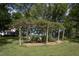 Wooden pergola covered in vines, with seating area at 6720 Mebane Oaks Rd, Mebane, NC 27302