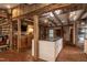 Open kitchen with island, exposed beams, and brick flooring at 6720 Mebane Oaks Rd, Mebane, NC 27302