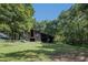 Rustic barn nestled in a lush, wooded setting at 6720 Mebane Oaks Rd, Mebane, NC 27302