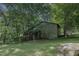Rustic wooden barn with split-rail fence and large rock at 6720 Mebane Oaks Rd, Mebane, NC 27302