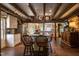 Large kitchen with exposed beams, island, and brick flooring at 6720 Mebane Oaks Rd, Mebane, NC 27302