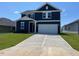 Two-story navy blue house with white garage at 352 Chestnut Oak Ln, Lillington, NC 27546