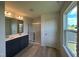 Double vanity bathroom with a walk-in shower and window at 352 Chestnut Oak Ln, Lillington, NC 27546