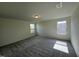 Well-lit bedroom featuring grey carpet and a large window at 352 Chestnut Oak Ln, Lillington, NC 27546