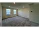 Spacious bedroom with grey carpet, neutral walls and two large windows at 352 Chestnut Oak Ln, Lillington, NC 27546