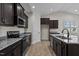 Modern kitchen with dark cabinets and granite countertops at 127 Hillwood Dr, Sanford, NC 27332