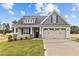 House exterior featuring beige siding and a two-car garage at 127 Hillwood Dr, Sanford, NC 27332
