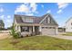 House exterior featuring beige siding and a two-car garage at 127 Hillwood Dr, Sanford, NC 27332