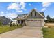House exterior featuring beige siding and a two-car garage at 127 Hillwood Dr, Sanford, NC 27332