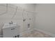 Bright laundry room with shelving and a utility sink at 127 Hillwood Dr, Sanford, NC 27332