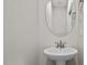 Small powder room with pedestal sink and oval mirror at 53 Hillwood Dr, Sanford, NC 27332