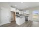 Modern kitchen with white cabinets, granite countertops, and stainless steel appliances at 53 Hillwood Dr, Sanford, NC 27332