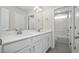 Double vanity bathroom with white cabinets and grey floor at 53 Hillwood Dr, Sanford, NC 27332