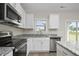 Modern kitchen features stainless steel appliances and granite countertops at 53 Hillwood Dr, Sanford, NC 27332