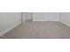 Well-lit bedroom with carpet, neutral walls, and doors at 53 Hillwood Dr, Sanford, NC 27332