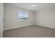 Carpeted bedroom with window and neutral walls at 53 Hillwood Dr, Sanford, NC 27332