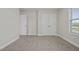 Bedroom with double doors and window, carpeted floor at 53 Hillwood Dr, Sanford, NC 27332