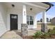 Front porch with stone columns and a black front door at 53 Hillwood Dr, Sanford, NC 27332