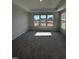 Bright bedroom with gray carpet and large windows at 1031 Westerland Way # 46, Durham, NC 27703