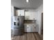 Stainless steel refrigerator and white cabinets highlight this kitchen at 1031 Westerland Way # 46, Durham, NC 27703