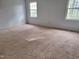 Spacious carpeted bedroom with two windows at 5604 Torness Ct, Raleigh, NC 27604