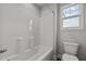 Clean bathroom with a bathtub, toilet, and window at 188 Hillwood Dr, Sanford, NC 27332