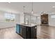 Open concept kitchen and Gathering room with a stone fireplace and island at 188 Hillwood Dr, Sanford, NC 27332