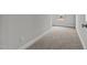 Long hallway with carpeted floors and a window at 188 Hillwood Dr, Sanford, NC 27332