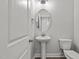 Clean powder room with pedestal sink and toilet at 188 Hillwood Dr, Sanford, NC 27332