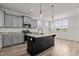 Modern kitchen with gray cabinets, granite countertops, and island at 188 Hillwood Dr, Sanford, NC 27332