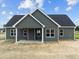 Rear view of gray house, showcasing the back porch and yard at 152 Hillwood Dr, Sanford, NC 27332