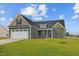 House with a two-car garage, gray siding, and a green lawn at 152 Hillwood Dr, Sanford, NC 27332