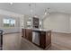 Open kitchen with island, stainless steel appliances, and living area view at 152 Hillwood Dr, Sanford, NC 27332
