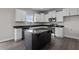 Modern kitchen with dark island and white cabinets at 114 Hillwood Dr, Sanford, NC 27332