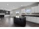 Open kitchen features island, white cabinets, and granite countertops at 114 Hillwood Dr, Sanford, NC 27332