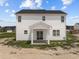 Rear view of a two-story house with white siding, a covered patio, and a partially landscaped yard at 114 Hillwood Dr, Sanford, NC 27332