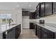 Modern kitchen with dark cabinets and granite countertops at 58 Hillwood Dr, Sanford, NC 27332