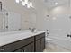 Bathroom with dark vanity, white countertop, and tub/shower combo at 58 Hillwood Dr, Sanford, NC 27332