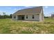 Tan house with covered patio, and large backyard at 58 Hillwood Dr, Sanford, NC 27332