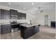 Open kitchen with island, stainless steel appliances, and dark cabinets at 58 Hillwood Dr, Sanford, NC 27332