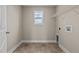 Laundry room with tile flooring, shelving, and a window for natural light at 147 Hillwood Dr, Sanford, NC 27332