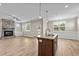 Open living room and kitchen with stone fireplace and island at 147 Hillwood Dr, Sanford, NC 27332