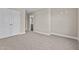 Spacious bedroom with carpet flooring and double doors leading to a private bathroom at 147 Hillwood Dr, Sanford, NC 27332